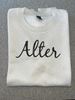 Picture of Alter High School - Adult/Unisex - Softstyle Crewneck w/ Brown Glitter Logo by Gildan SF000 -  Brown Savana or Sand